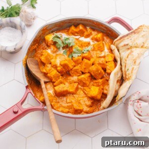 Butter paneer in a pan with naan.