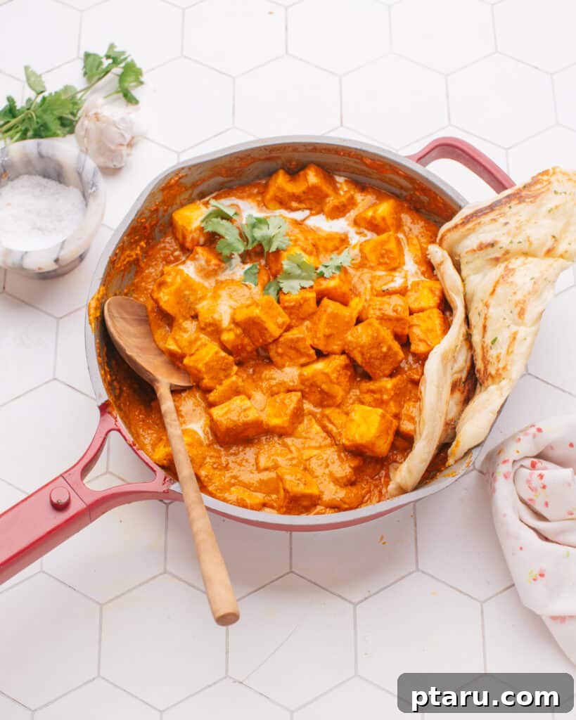Creamy Butter Paneer 3 Butter paneer in a pan with homemade naan on the side, ready for dipping.
