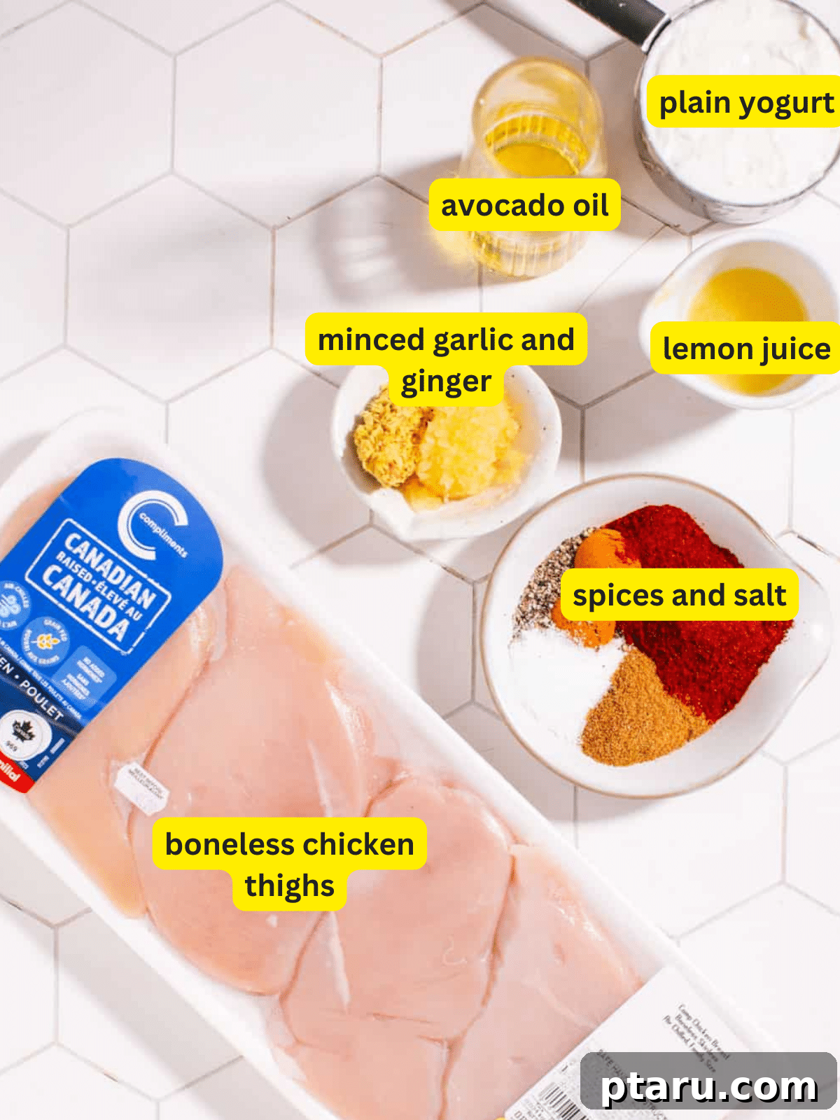 The Best Chicken Tikka Recipe For Grill Oven Or Air Fryer 3 A flat lay of fresh ingredients for chicken tikka marinade including yogurt, lemon, garlic, ginger, and various Indian spices.