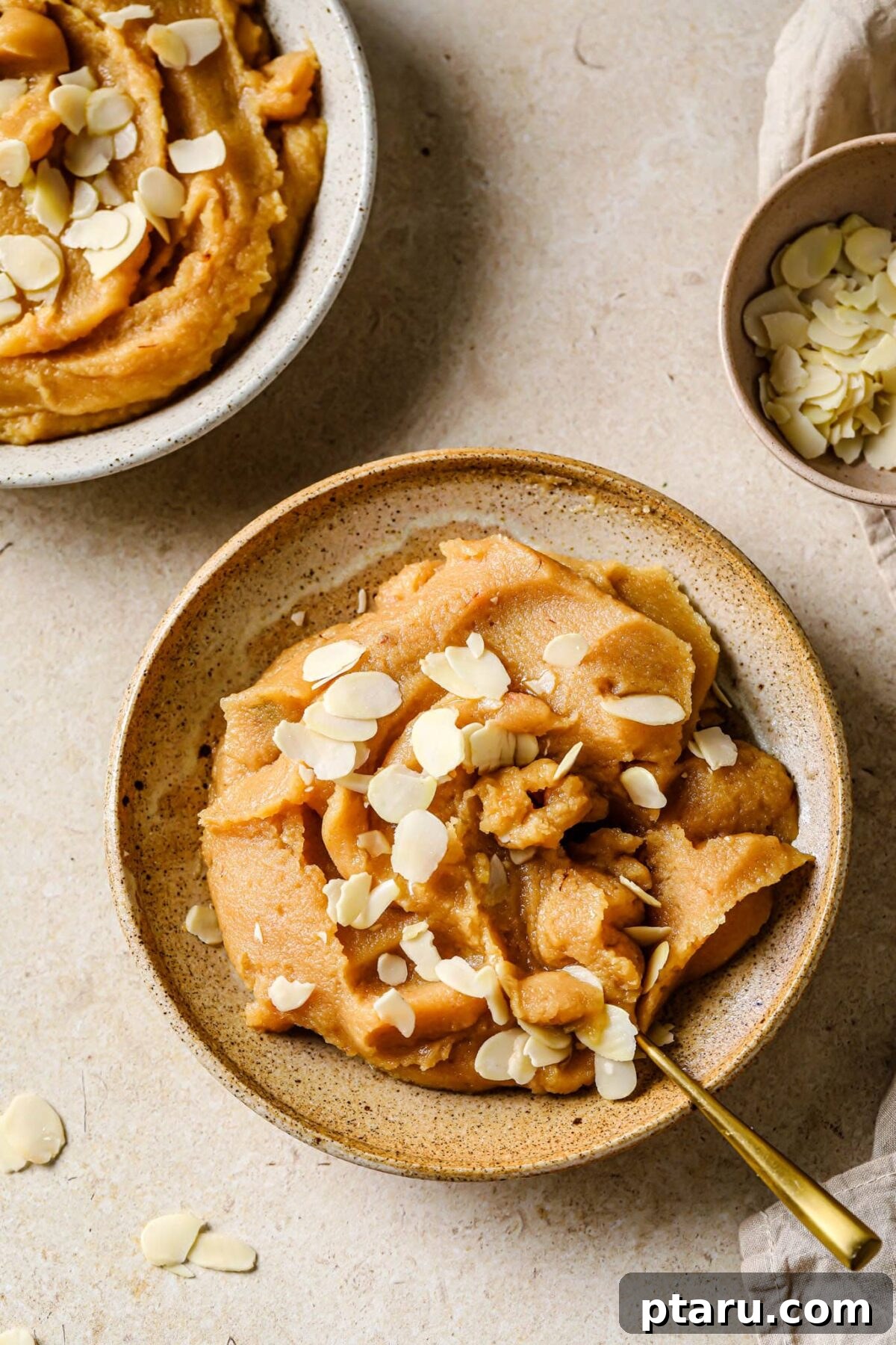 Easy Indian Desserts and Sweets: Crowd-Pleasing Showstoppers 13 A bowl of warm Sooji Halwa, a rich semolina pudding garnished with nuts and scented with cardamom.