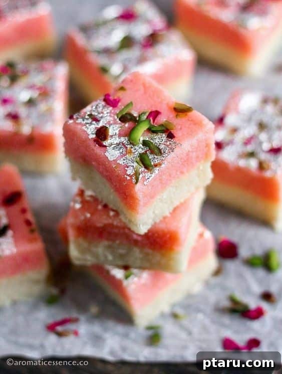 Easy Indian Desserts and Sweets: Crowd-Pleasing Showstoppers 15 Neatly cut squares of Coconut Burfi, a sweet Indian fudge often garnished.