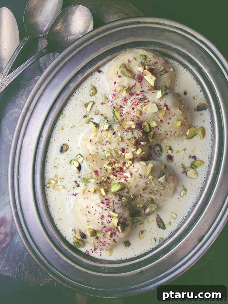Easy Indian Desserts and Sweets: Crowd-Pleasing Showstoppers 28 A bowl of creamy Vegan Rasmalai, plant-based cheese patties soaked in flavored milk, garnished.