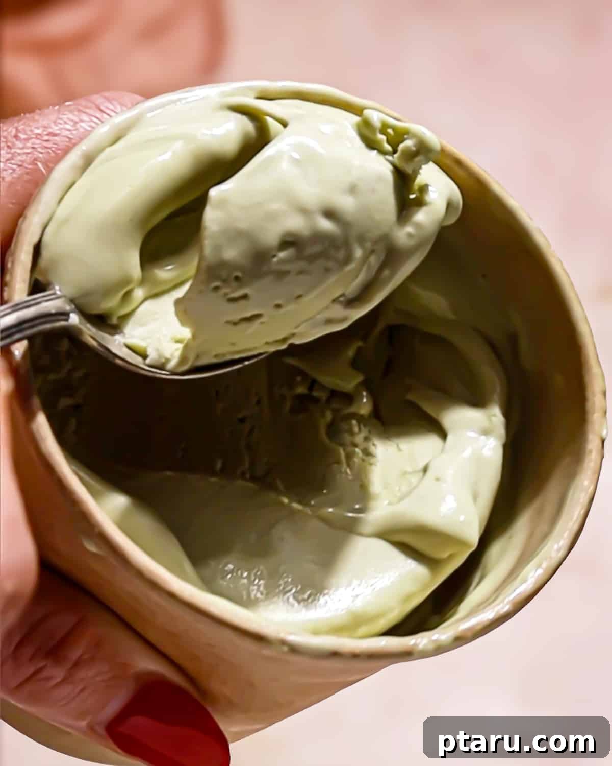 Easy Indian Desserts and Sweets: Crowd-Pleasing Showstoppers 5 Scooping rich, green pistachio ice cream into a container, showcasing its creamy texture.
