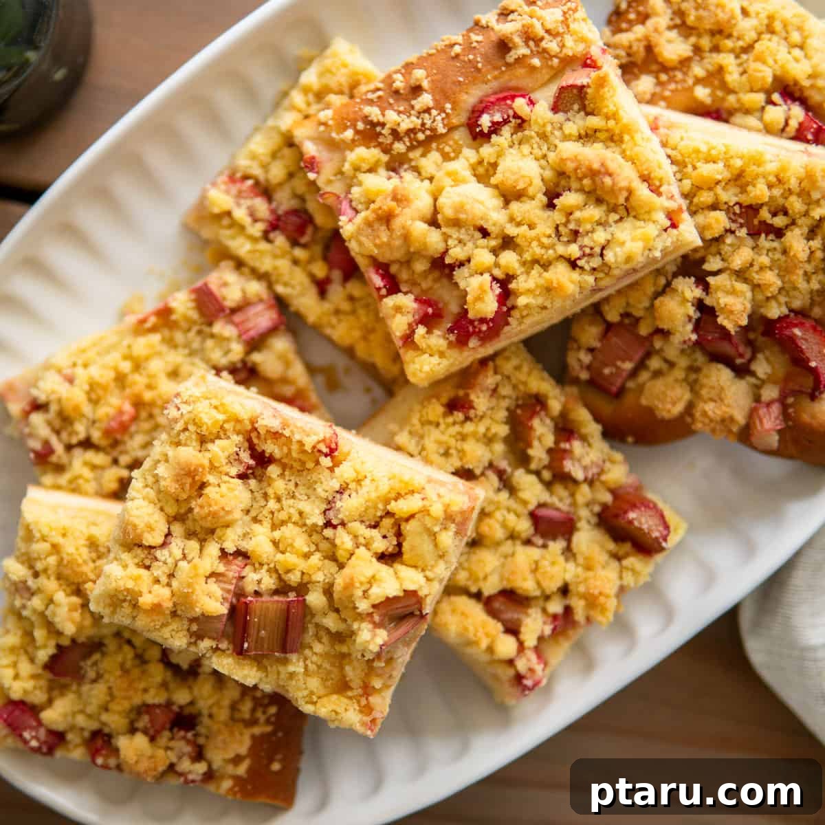 Favorite Easy Rhubarb Recipes You'll Make Forever 27 A large sheet cake with rhubarb and streusel topping, showcasing its beautiful texture.