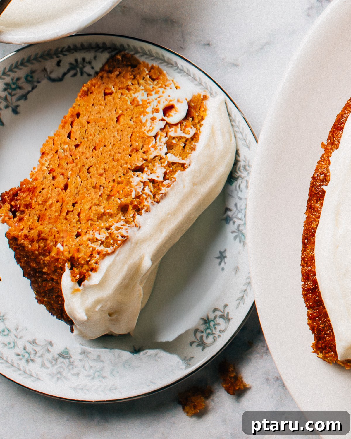 Golden Autumn Spice Cake 2 Delicious Pumpkin Spice Cake generously topped with cream cheese frosting, perfect for fall celebrations.