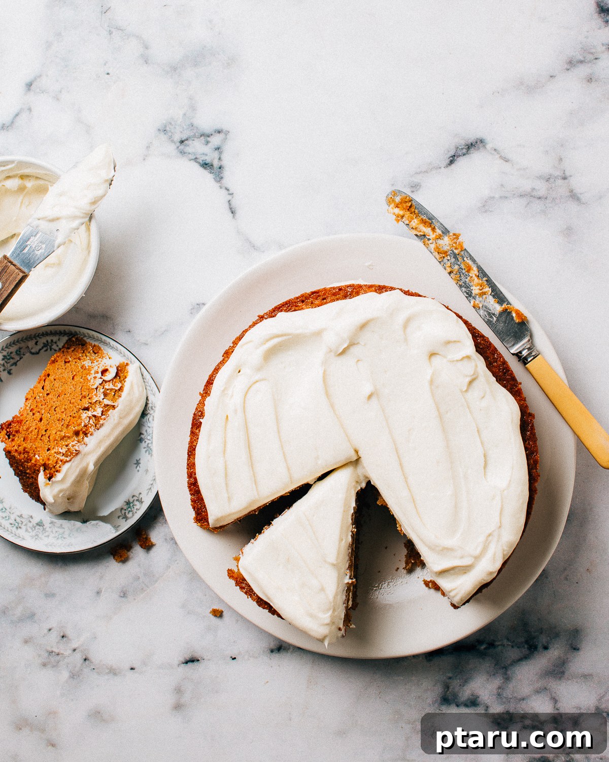 Golden Autumn Spice Cake 4 A slice of moist pumpkin spice cake with a generous dollop of cream cheese frosting on a serving plate, ready to be enjoyed.