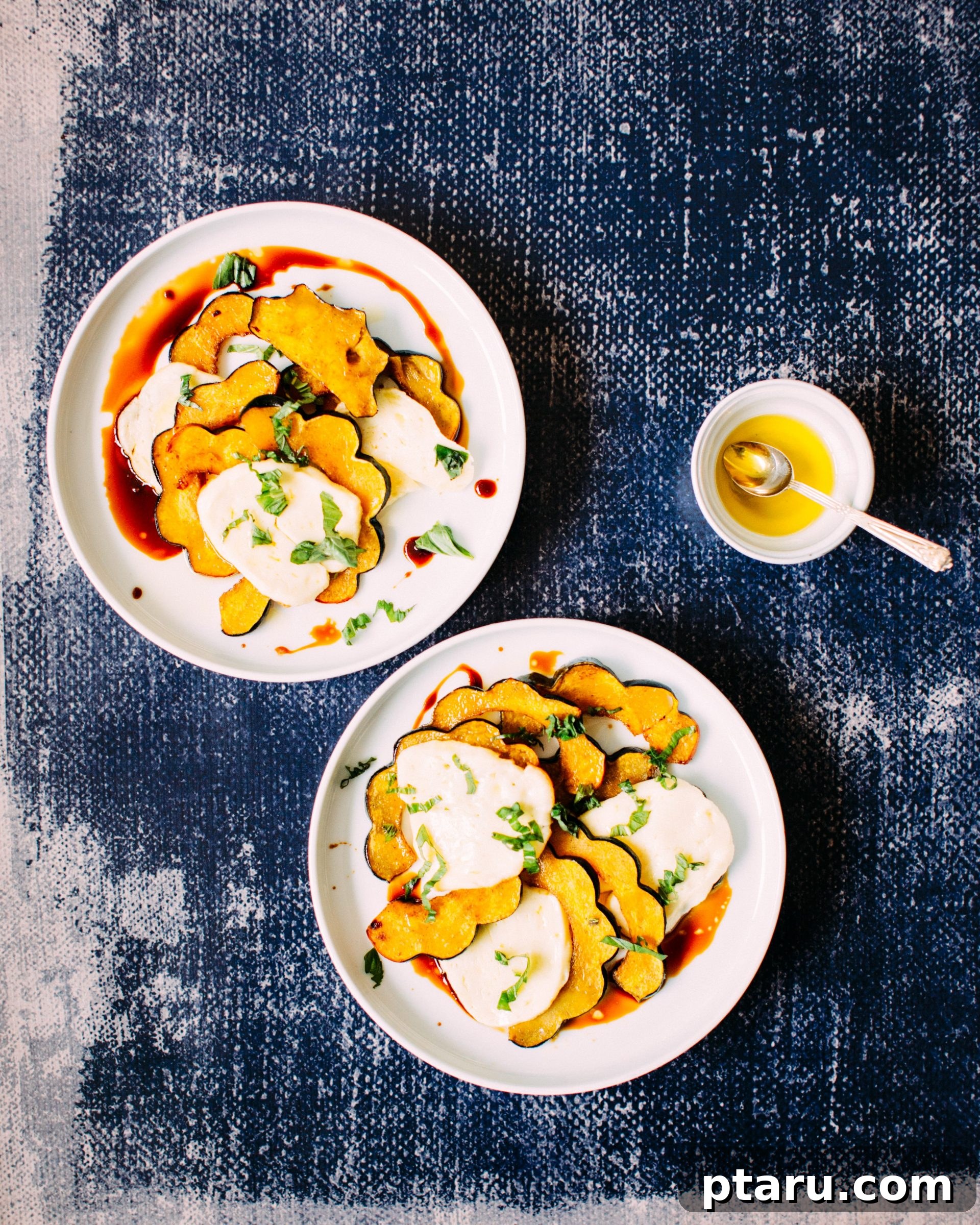 Golden-Roasted Maple-Spiced Squash and Halloumi Salad 2 A beautifully plated Spiced Maple-Roasted Squash & Halloumi Salad, showcasing vibrant colors and fresh basil.
