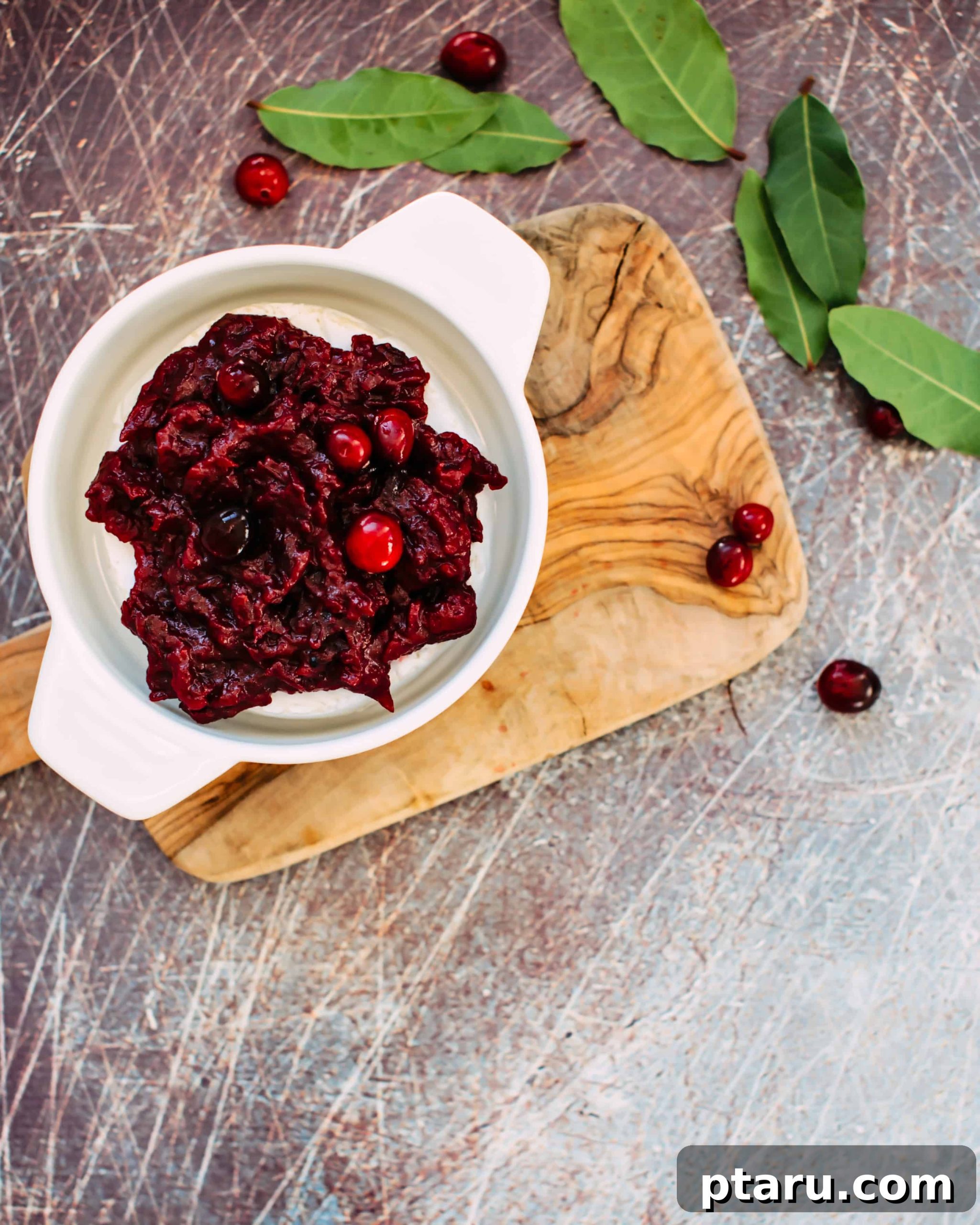 Warm Brie with Zesty Cranberry-Ginger Chutney 4 A wheel of Brie topped with cranberry ginger chutney, ready for baking