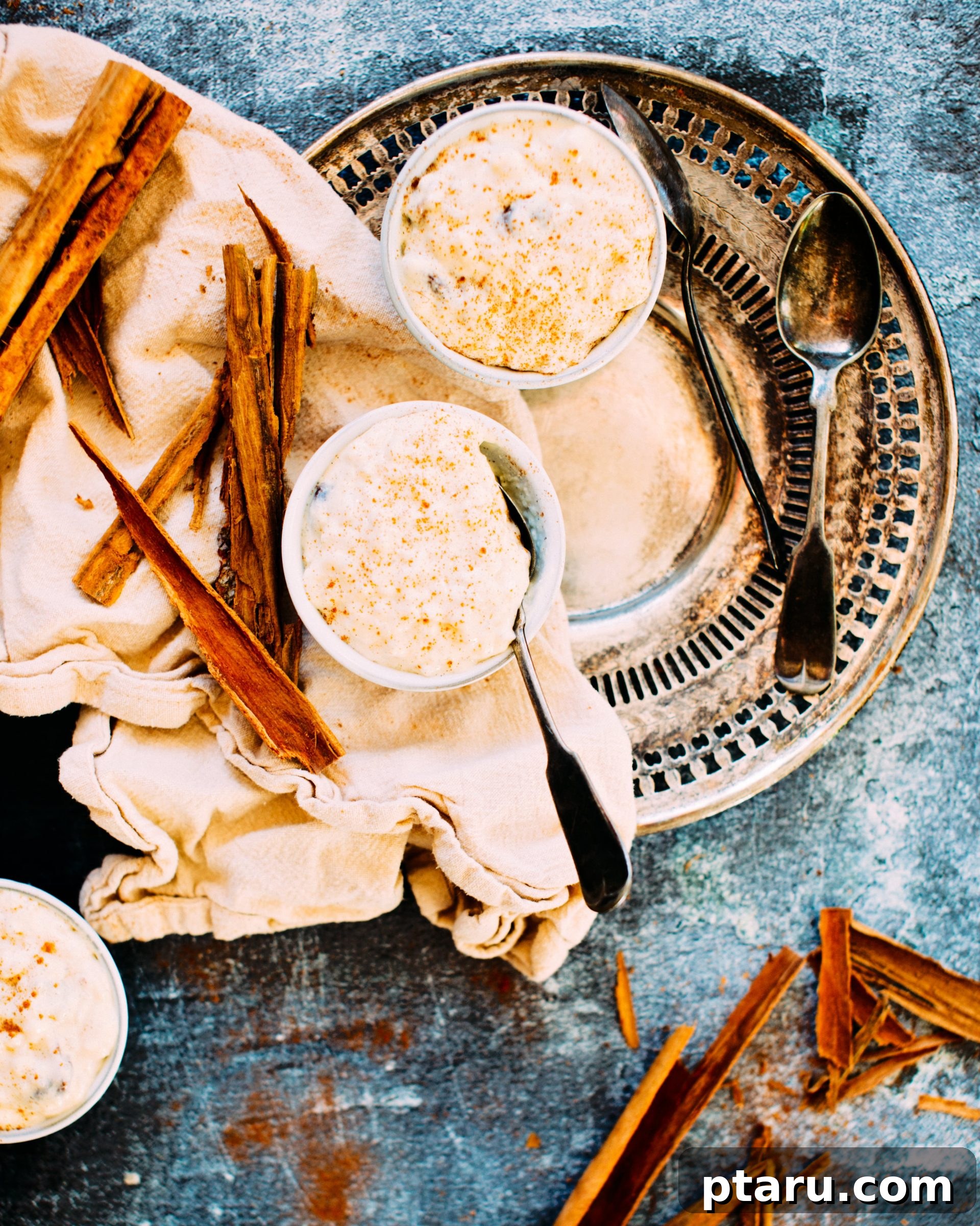 Warm Cinnamon Raisin Comfort 2 A steaming bowl of creamy cinnamon raisin rice pudding, garnished with a cinnamon stick.