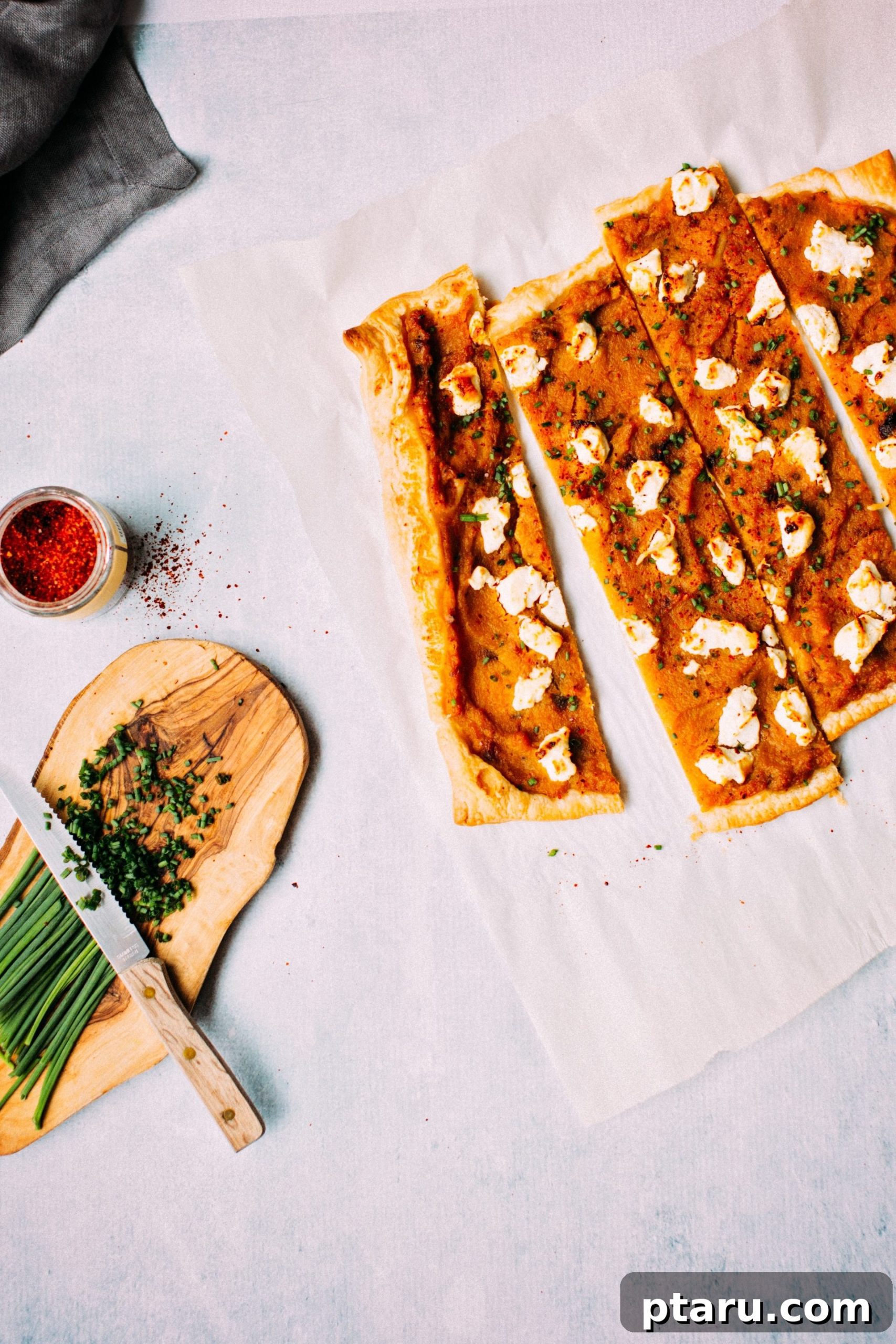 Easy Savory Squash Tart with Roasted Garlic and Goat Cheese 5 A tempting overhead shot of the full Roasted Squash, Garlic + Goat Cheese Tart before slicing, adorned with fresh chives