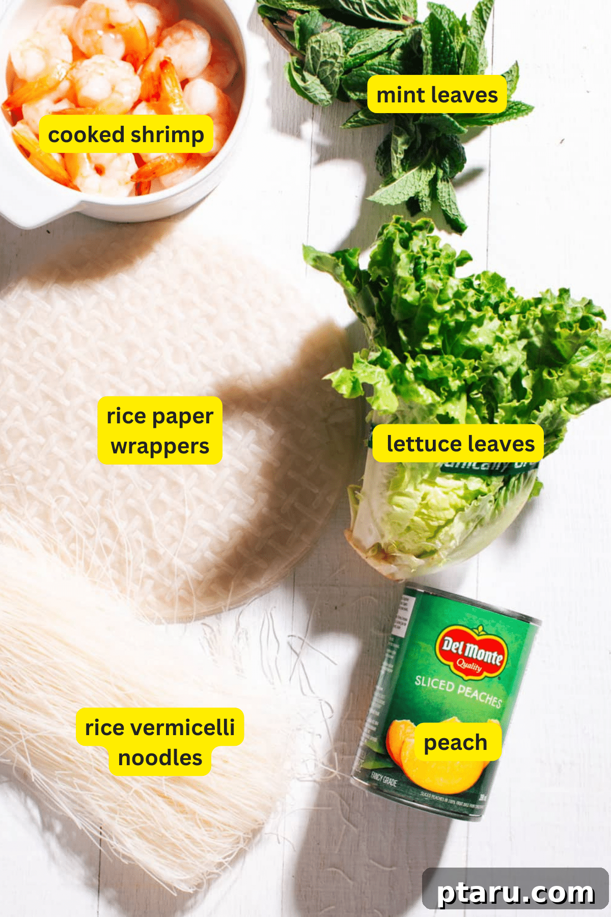 Fresh and Easy Homemade Spring Rolls 3 Assortment of fresh spring roll ingredients including shrimp, noodles, rice paper, lettuce, and fruit.