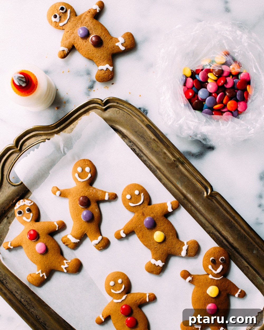 Irresistibly Soft and Chewy Gingerbread Men 4 Gingerbread cookie dough being rolled between two sheets of parchment paper