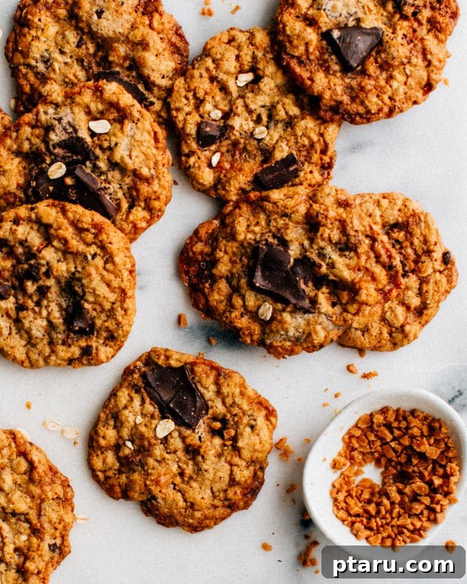 Heavenly Toffee Oatmeal Chocolate Treasures 4 Freshly baked Toffee Oatmeal Chocolate Chunk Cookies cooling on a metal wire rack.