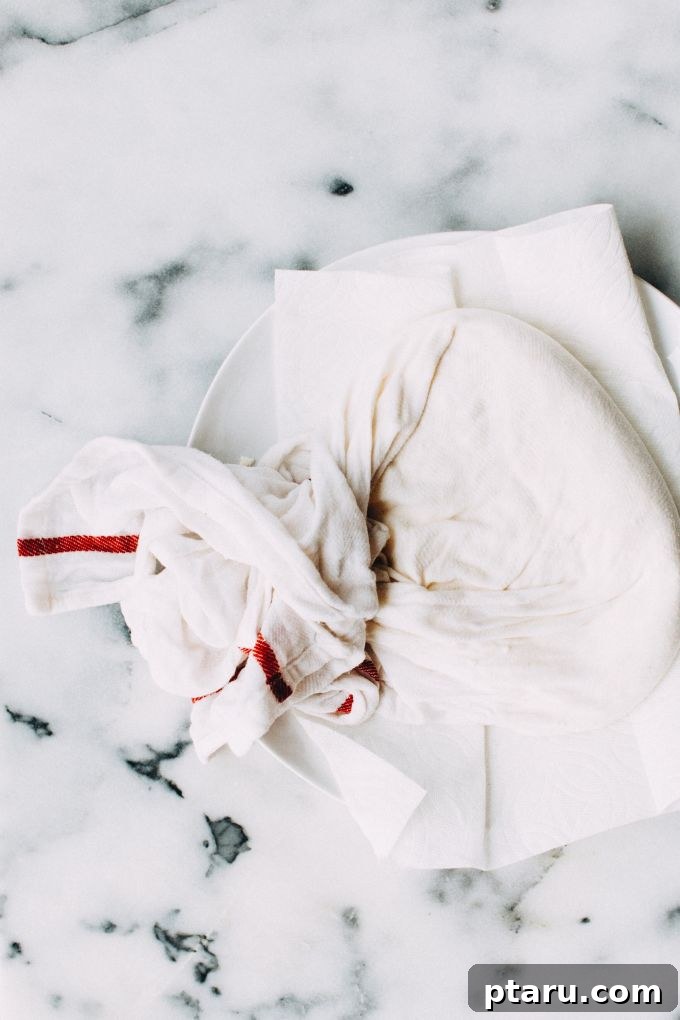 Effortless Homemade Paneer Your Step by Step Guide 8 Salt being added to the freshly strained paneer curds.
