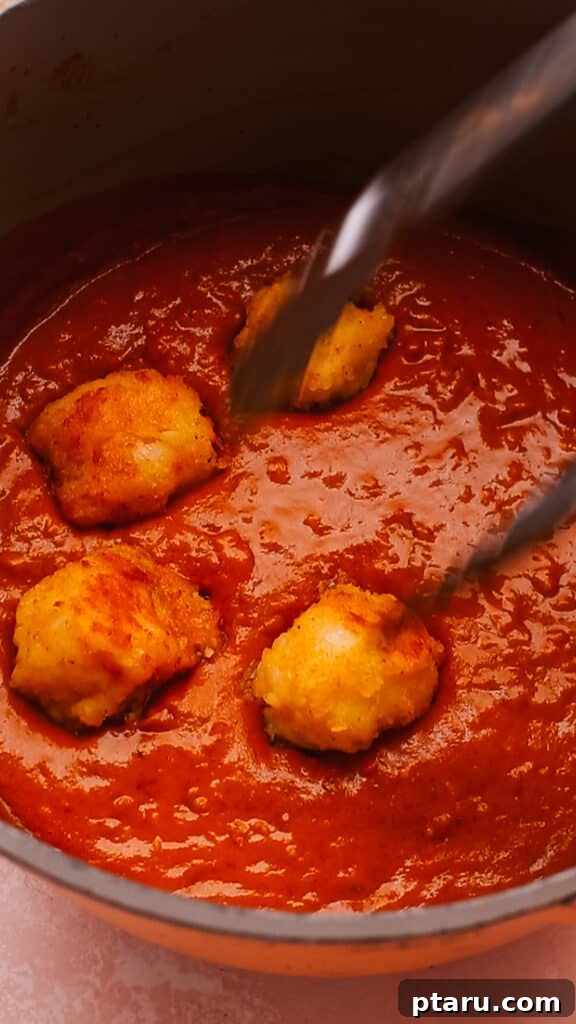Simple Creamy Paneer Malai Kofta Curry 12 Gently adding fried kofta balls to the simmering creamy curry sauce.