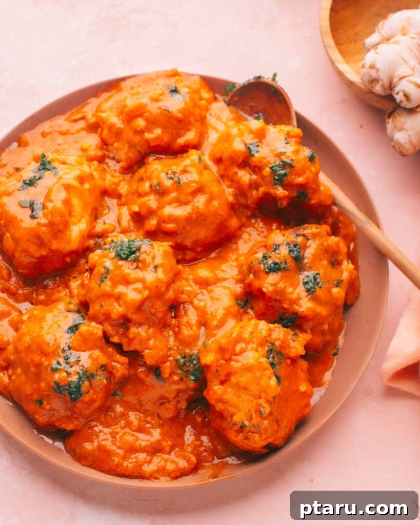 Simple Creamy Paneer Malai Kofta Curry 17 A close-up of Malai Kofta with a spoon, showing the rich texture of the curry and tender dumplings.