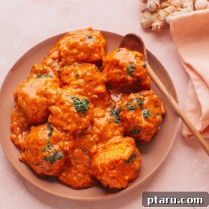 Malai Kofta on a plate with a spoon.