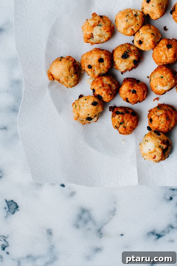 Simple Creamy Paneer Malai Kofta Curry 3 Crispy vegetarian kofta balls with hints of raisins on a white plate, ready for the curry.