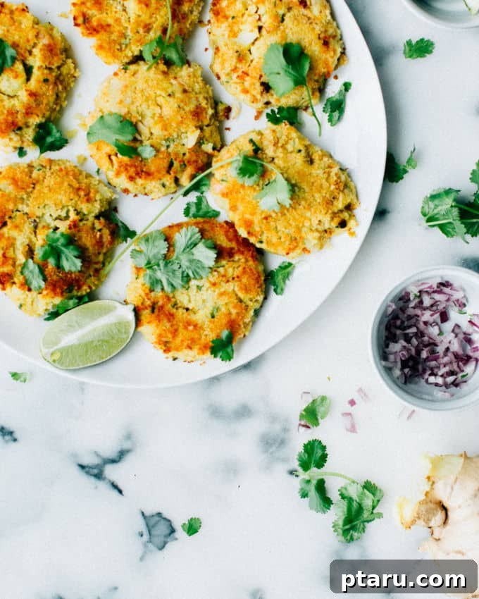 Spiced Indian Fish Fritters 2 Golden brown Kerala-style fish cutlets on a plate, garnished with fresh cilantro.