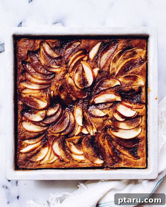 Apple Crumble Cake 4 A full Apple Pie Cake on a cooling rack, steam gently rising, highlighting the golden-brown caramelized apples.