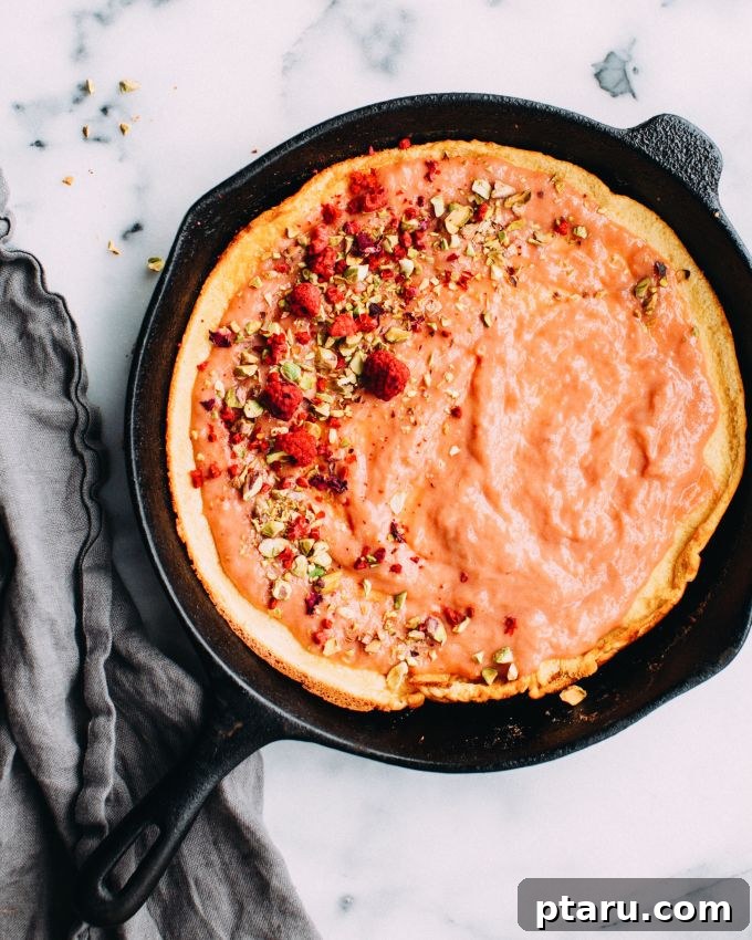 Tangy Rhubarb Skillet Puff 2 Rhubarb Dutch Baby pancake served with a generous amount of rhubarb curd on top, garnished with mint leaves