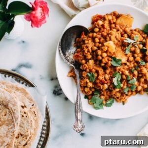 Chickpea curry with phulka roti on a plate, ready to be enjoyed.