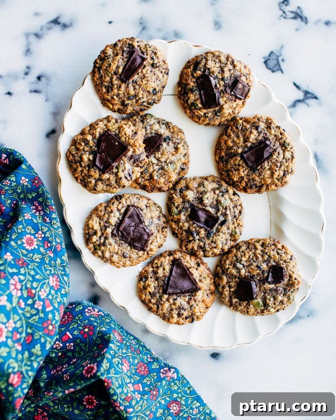 Wholesome Currant and Seed Cookies 4 A small child's hand reaching for a wholesome cookie placed on green grass, emphasizing summer and outdoor enjoyment.