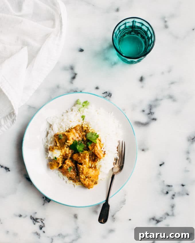 Fiery Goan Pork Vindaloo 7 Easy pork vindaloo curry on a marble counter with a blue glass of water.