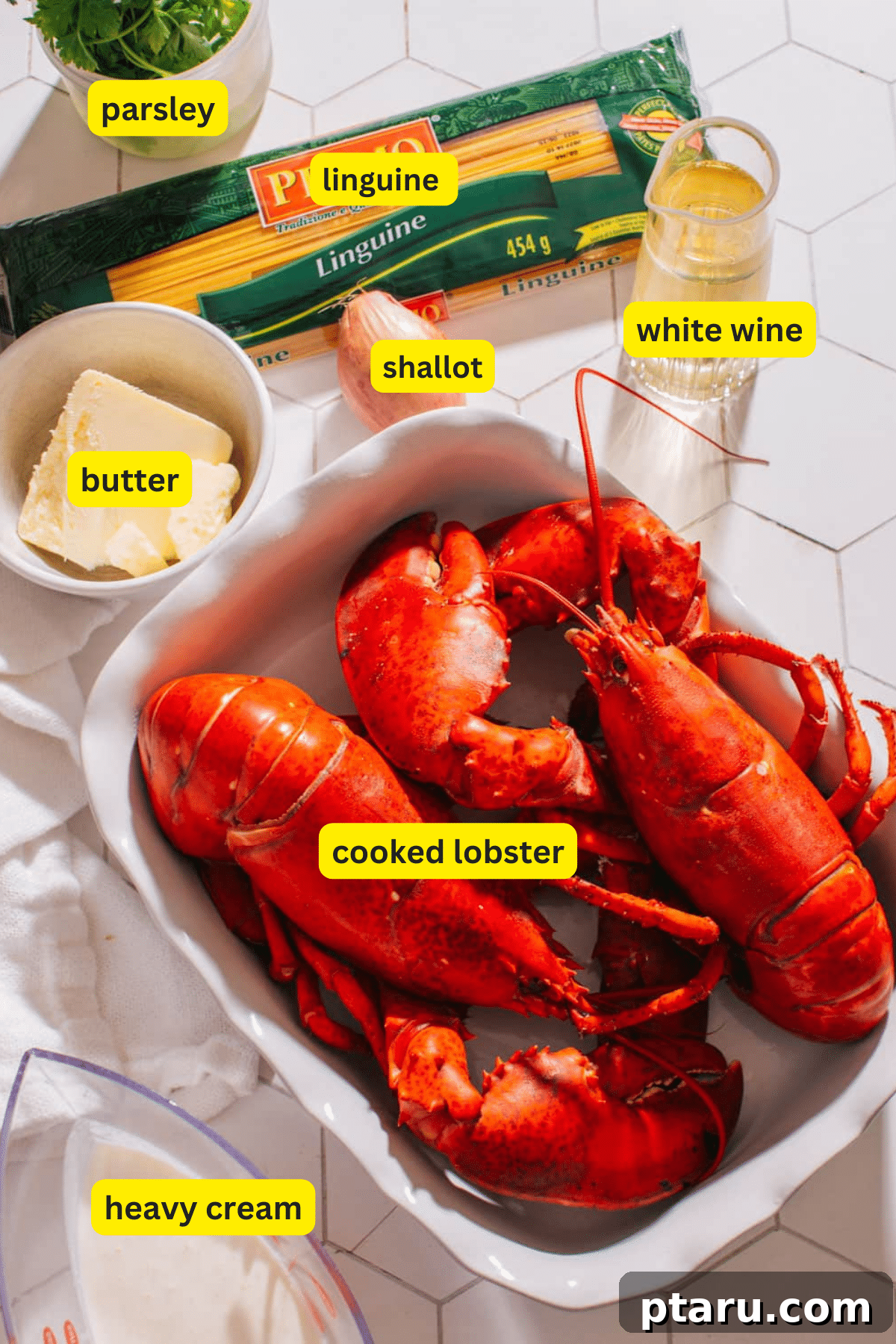 Decadent Lobster Pasta with White Wine Cream 3 Collection of fresh ingredients for lobster pasta, including lobster, pasta, cream, and herbs.