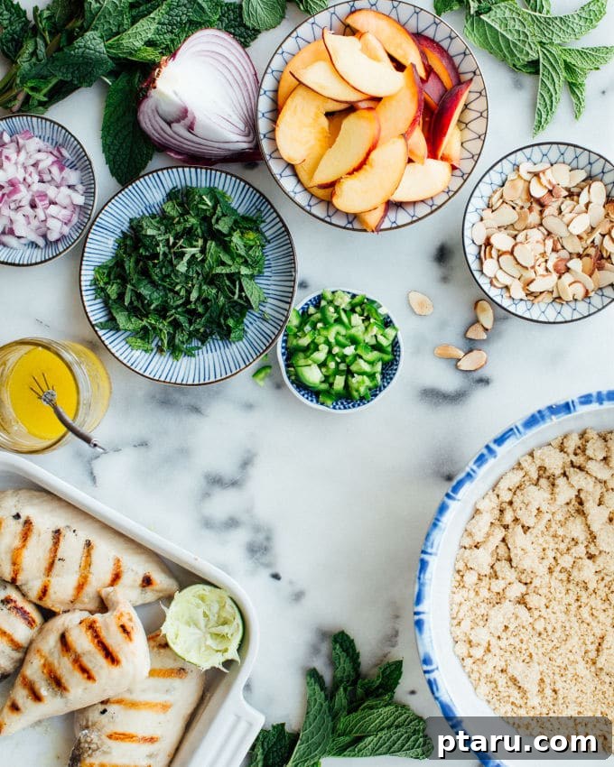Peachy Mint Grilled Chicken Couscous Salad 4 A large serving bowl filled with colorful Grilled Chicken & Couscous Salad