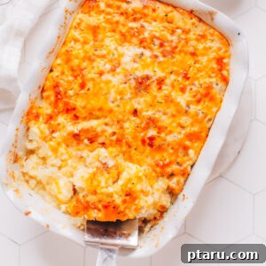 Simply Delicious Chicken Potato Casserole 7 Chicken potato casserole with a scoop being removed with a serving spoon.
