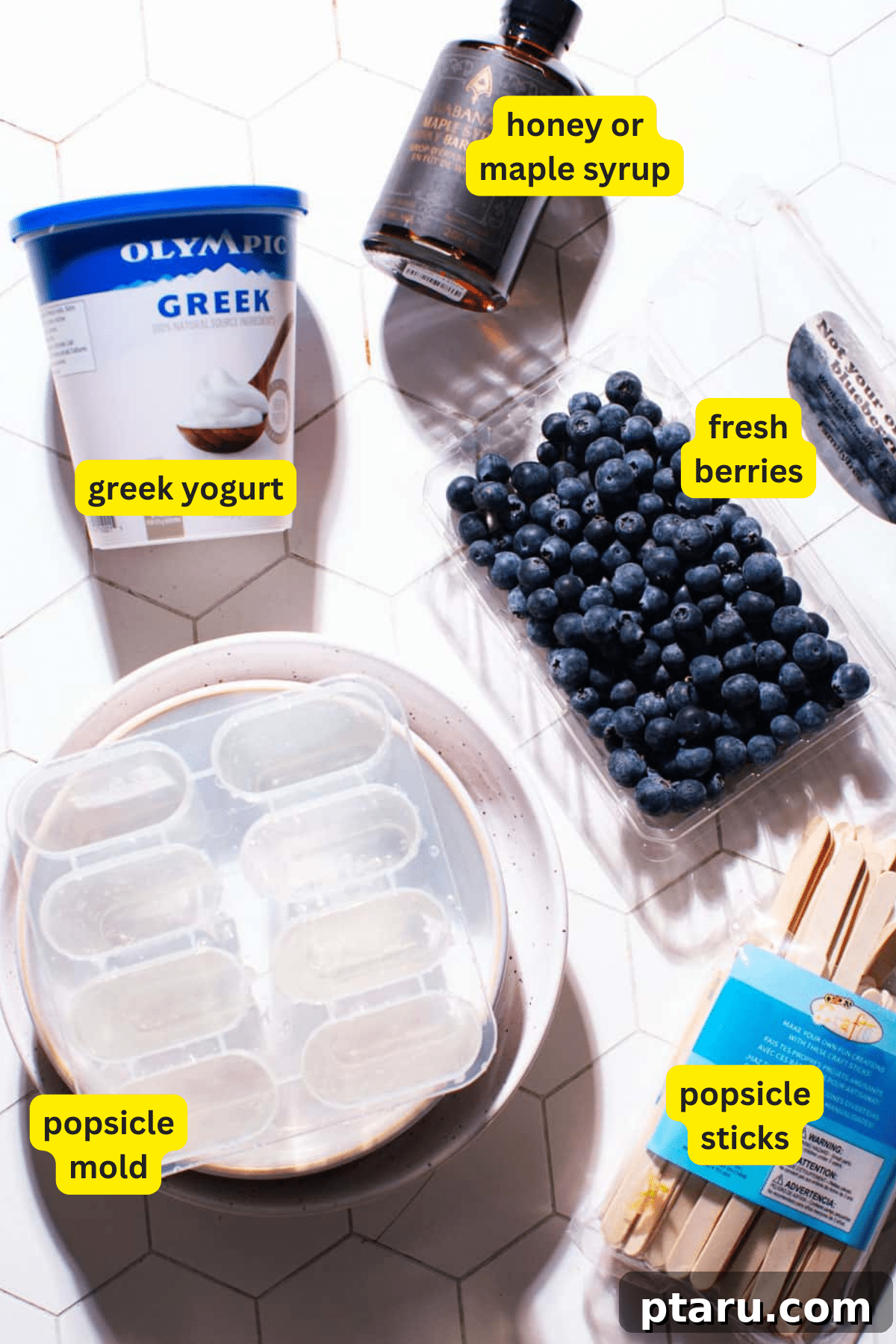 Easy 5-Minute 3-Ingredient Yogurt Popsicles 3 Yogurt Popsicle Ingredients laid out: Greek yogurt, honey, and fresh berries.