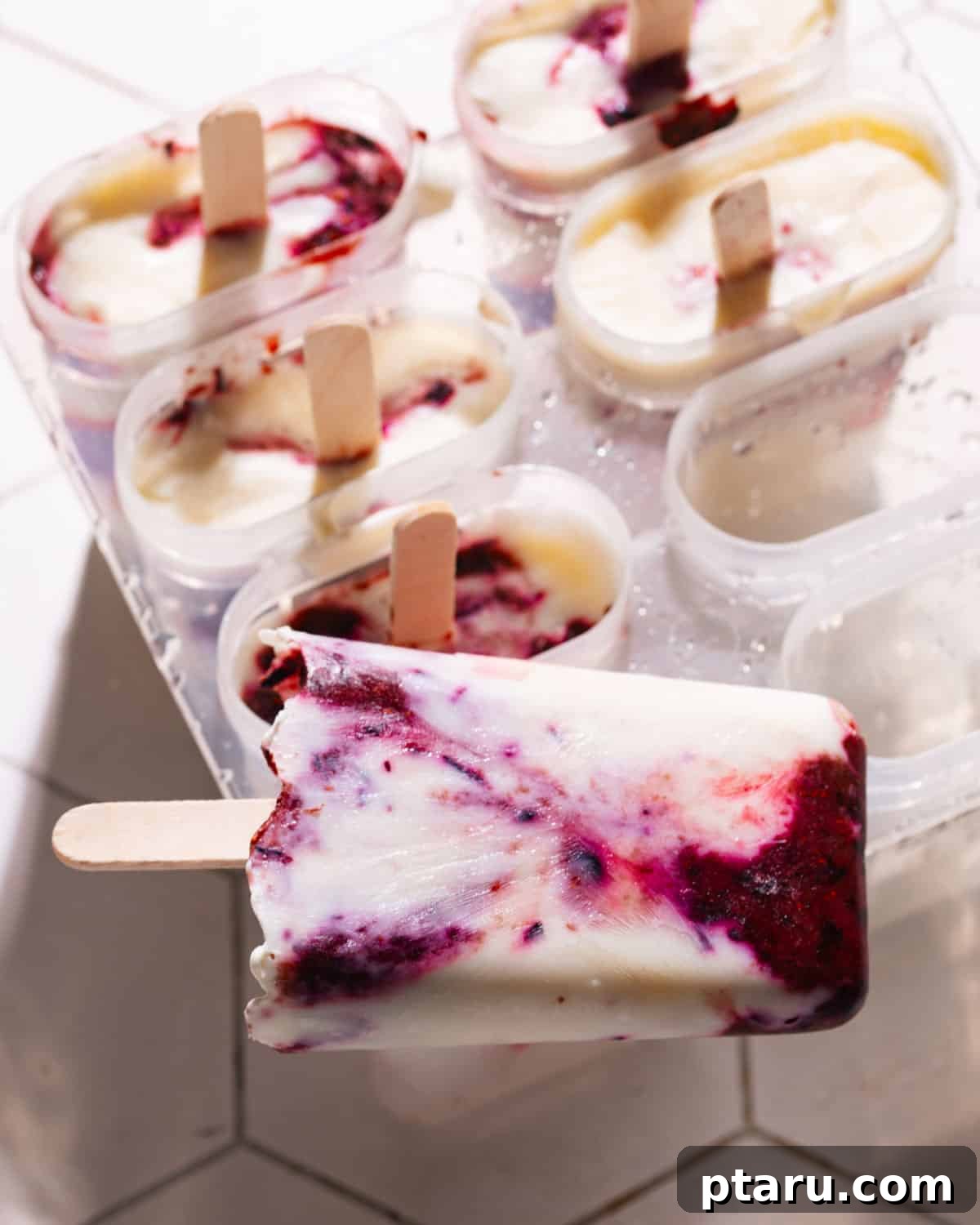 Easy 5-Minute 3-Ingredient Yogurt Popsicles 6 Yogurt popsicle lying on top of popsicle mould, ready for storage.