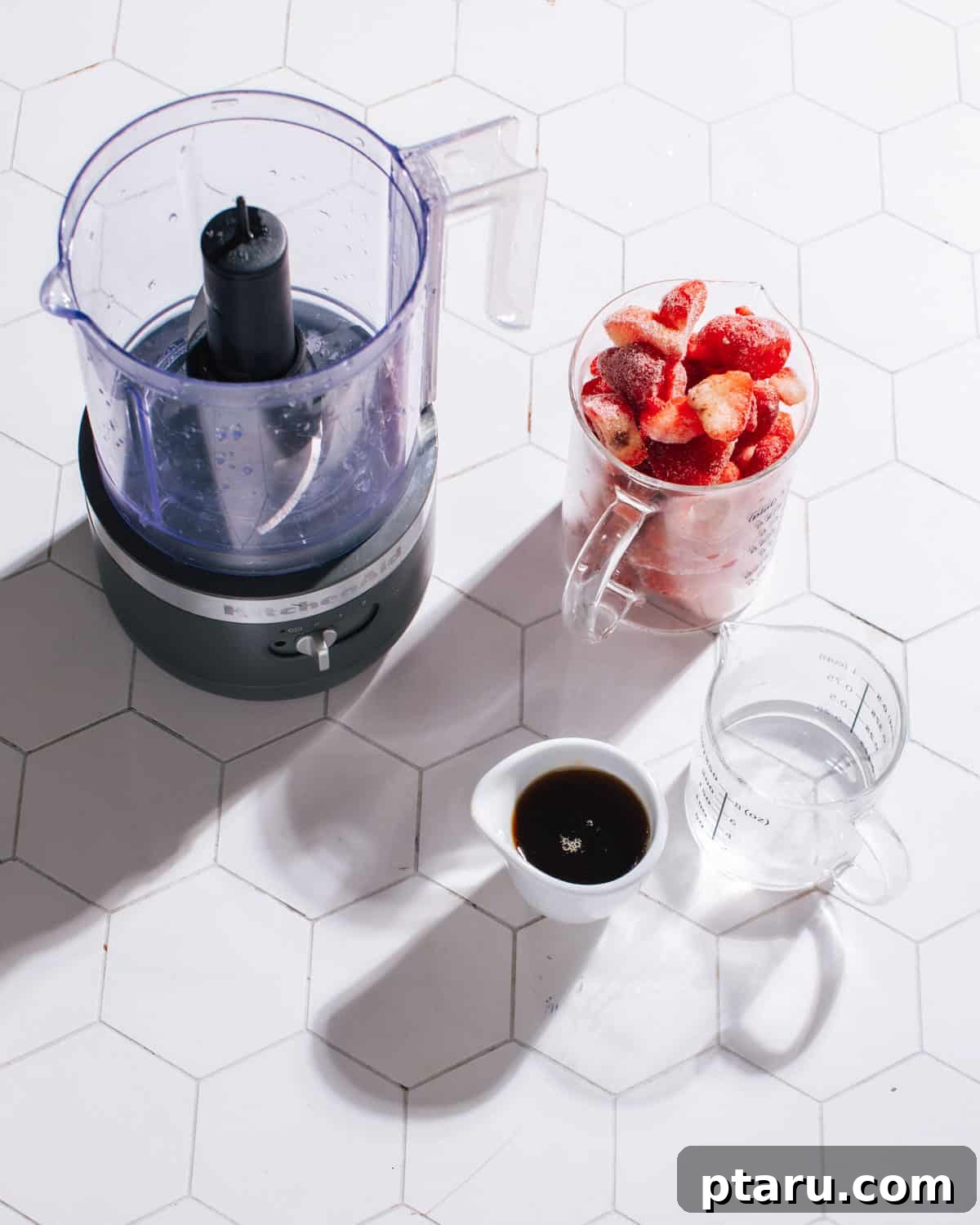Effortless Three Ingredient Strawberry Pops 4 A visual display of the simple ingredients needed for strawberry popsicles: fresh strawberries, honey, and water.