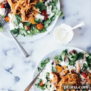 Zesty Chicken Fattoush with Creamy Garlic Yogurt Dressing 4 A top-down view of a colorful Chicken Fattoush Salad with a side of creamy garlic-yogurt dressing.
