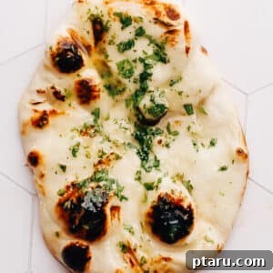 Garlic naan on a countertop, top-down view for the recipe card.