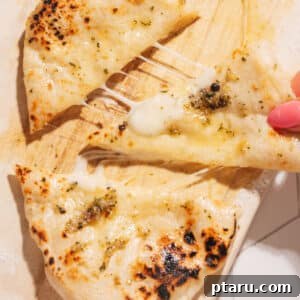 Cheese Naan being pulled apart.