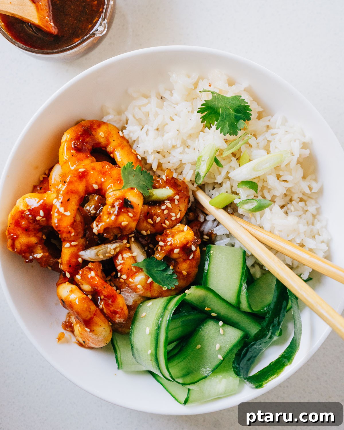 20+ Guilt-Free Shrimp Recipes for Dinner: Absolutely Delicious! 2 Teriyaki Shrimp in a bowl, garnished with sesame seeds and green onions.