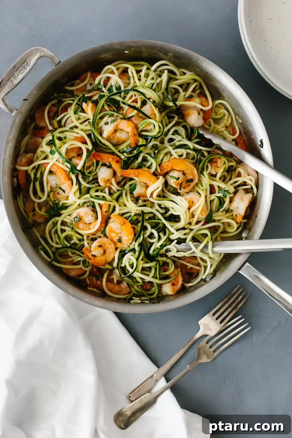 20+ Guilt-Free Shrimp Recipes for Dinner: Absolutely Delicious! 14 Shrimp and Zucchini Noodles in a bowl, garnished with fresh herbs.
