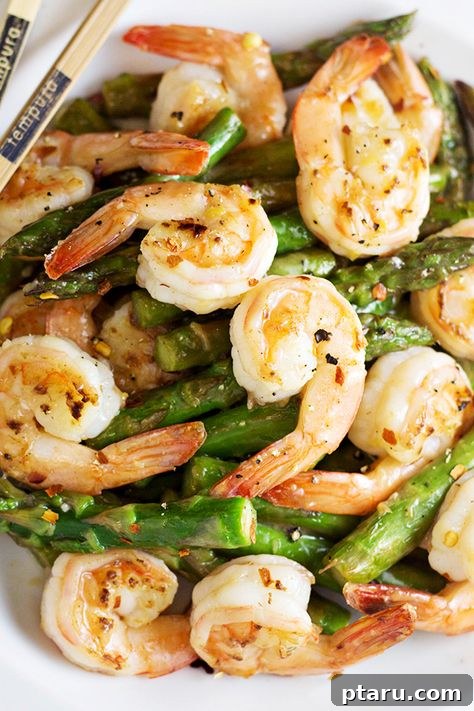 20+ Guilt-Free Shrimp Recipes for Dinner: Absolutely Delicious! 19 Shrimp and Asparagus Stir-Fry in a pan, vibrant and fresh.