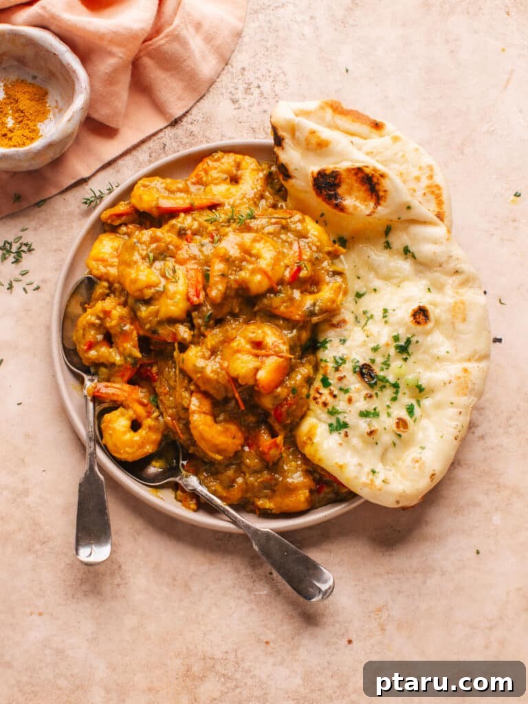 20+ Guilt-Free Shrimp Recipes for Dinner: Absolutely Delicious! 6 Curry shrimp with naan bread, garnished with fresh cilantro.