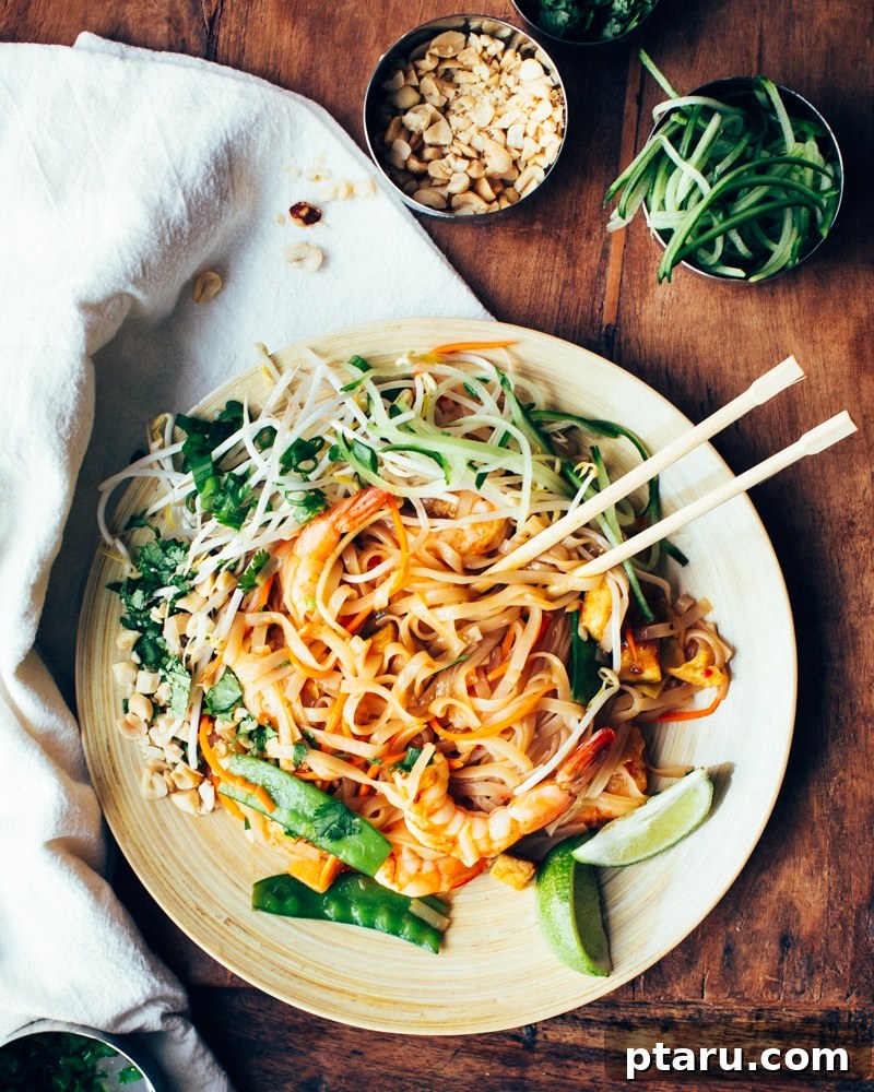 20+ Guilt-Free Shrimp Recipes for Dinner: Absolutely Delicious! 10 Veggie, Shrimp and Tofu Pad Thai on Foodess-2, garnished with peanuts and lime.
