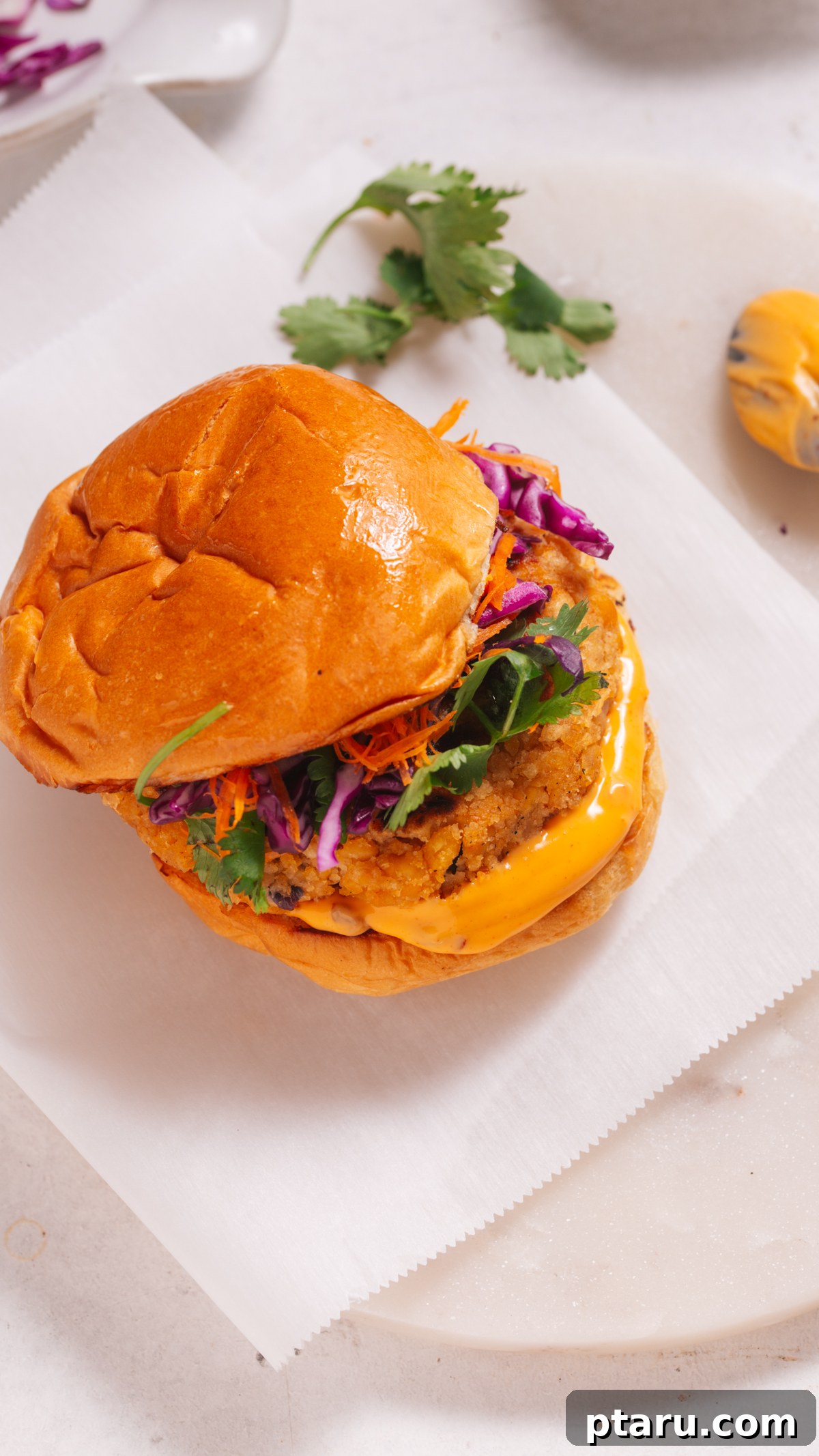 Savory Chickpea Burgers 4 Two cooked chickpea burgers on toasted buns with various fresh toppings like lettuce and pickles.