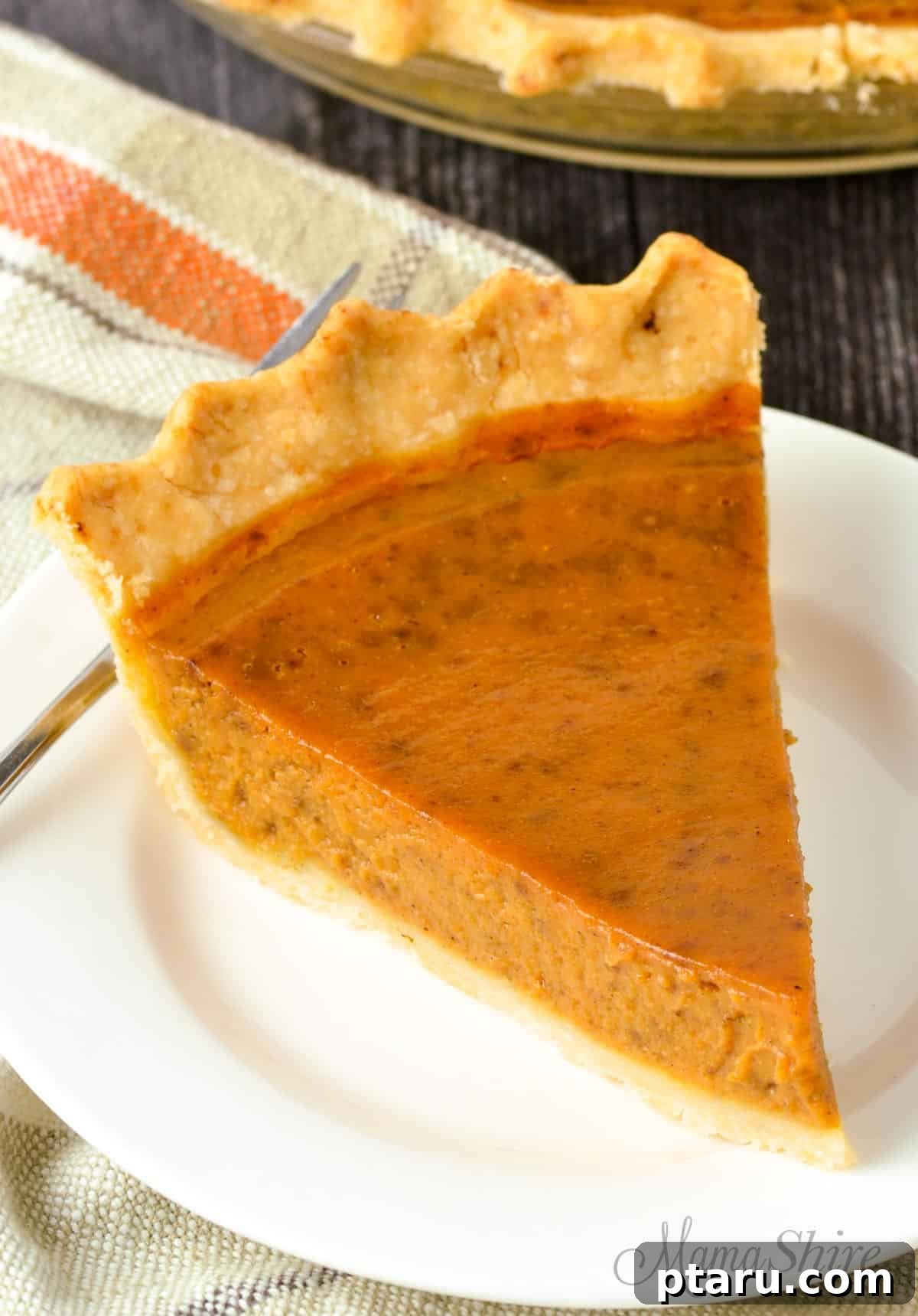 Decadent Gluten and Dairy Free Treats 21 Slice of dairy-free pumpkin pie on a plate, garnished with whipped cream