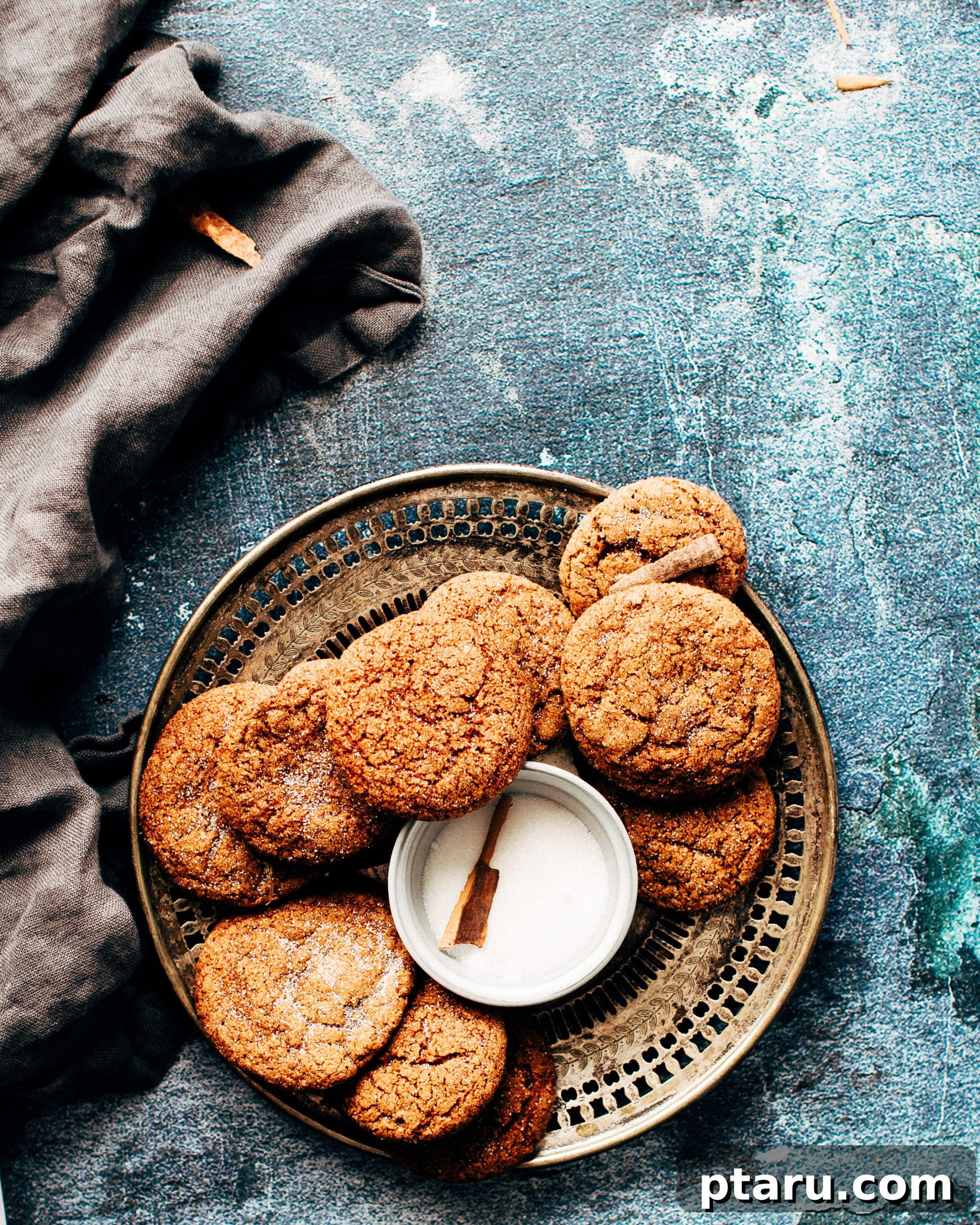 Soft and Chewy Apple-Cinnamon Gingersnaps 2 A plate of golden brown, sugar-coated soft and chewy apple-cinnamon gingersnap cookies, perfectly baked and ready to eat.