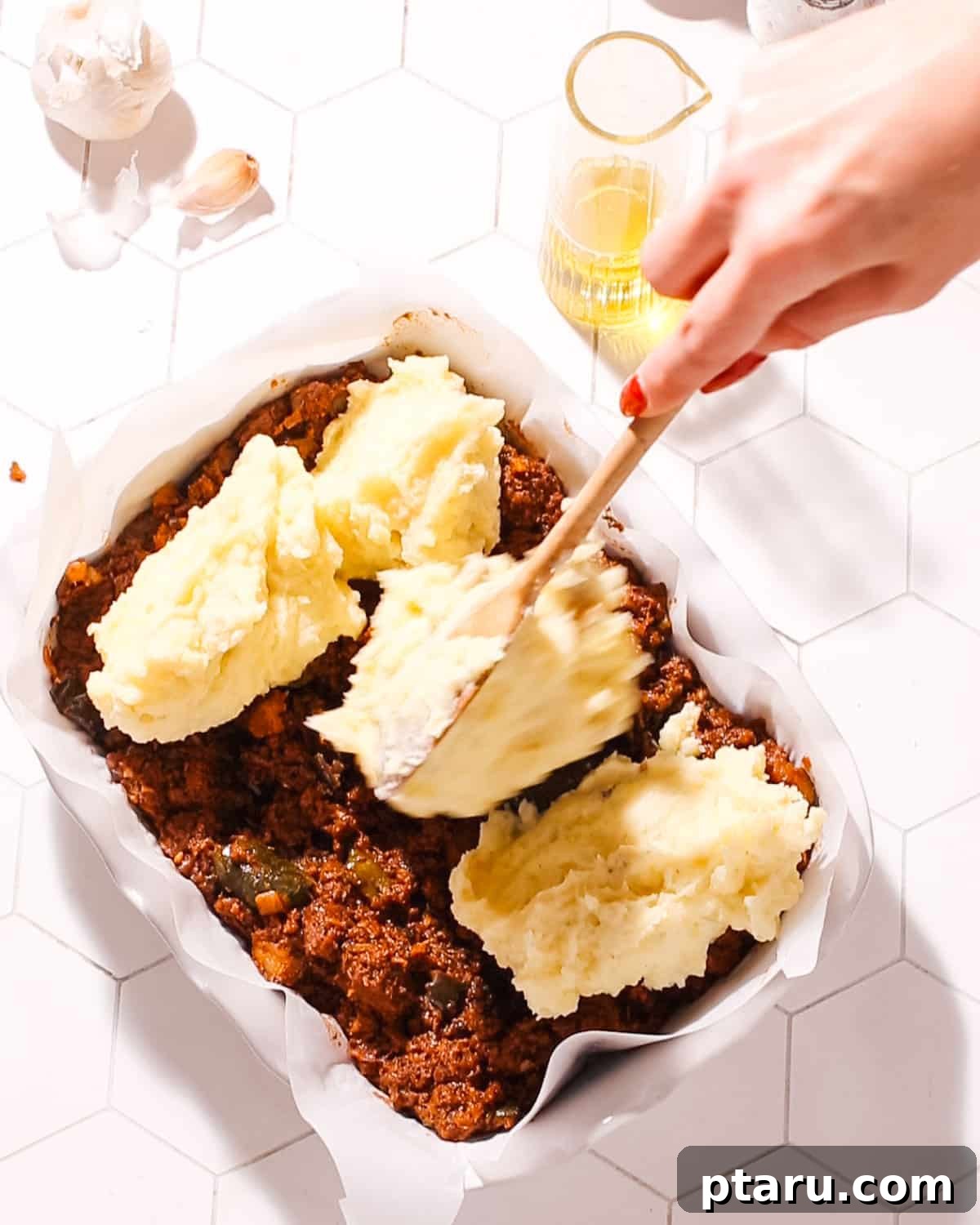 26 Hearty Meat Sauce Recipes: Delicious Dinners and Easy Leftovers 3 Adding potato topping to Greek Shepherd's Pie.