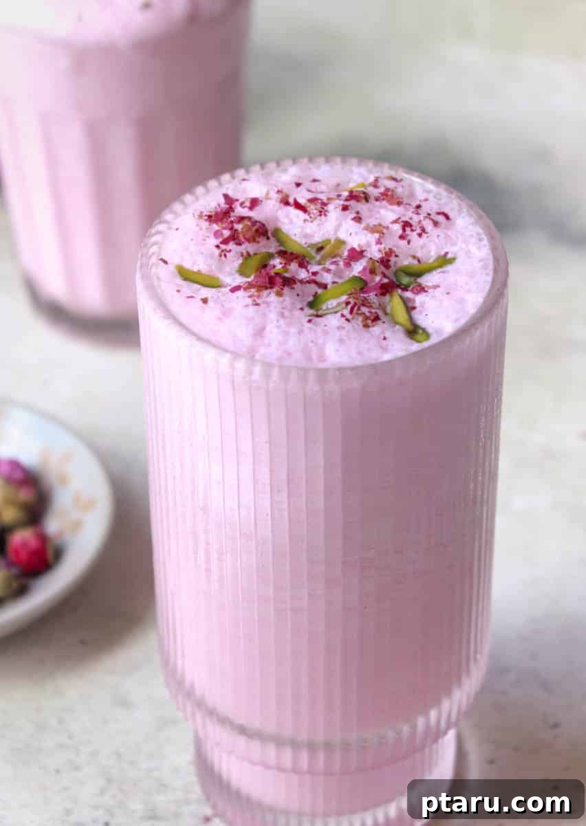 The Ultimate Guide to Indian Beverage Recipes 23 Rose Lassi, a beautiful pink yogurt drink with a frothy topping.