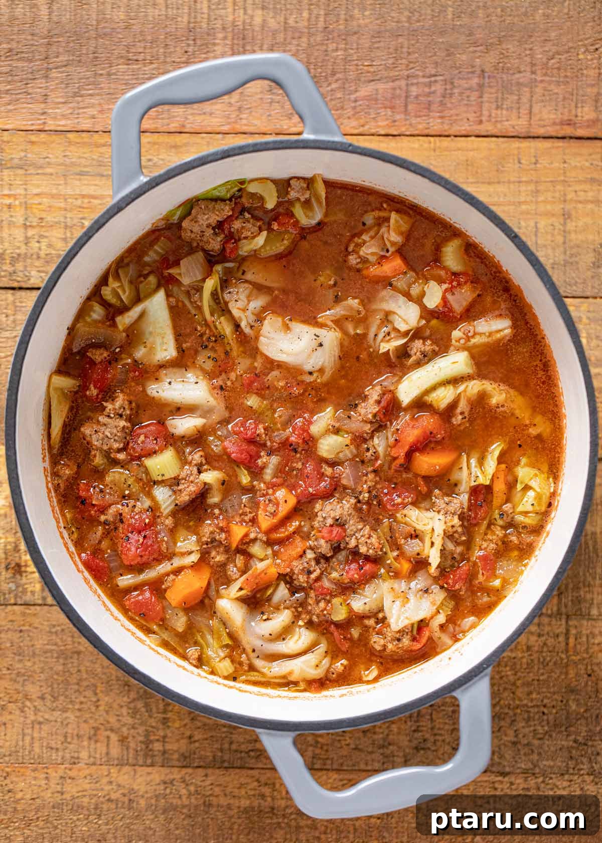 The Ultimate Ground Beef and Cabbage Recipe Collection 4 A bowl of comforting Cabbage and Beef Soup, garnished with fresh herbs.