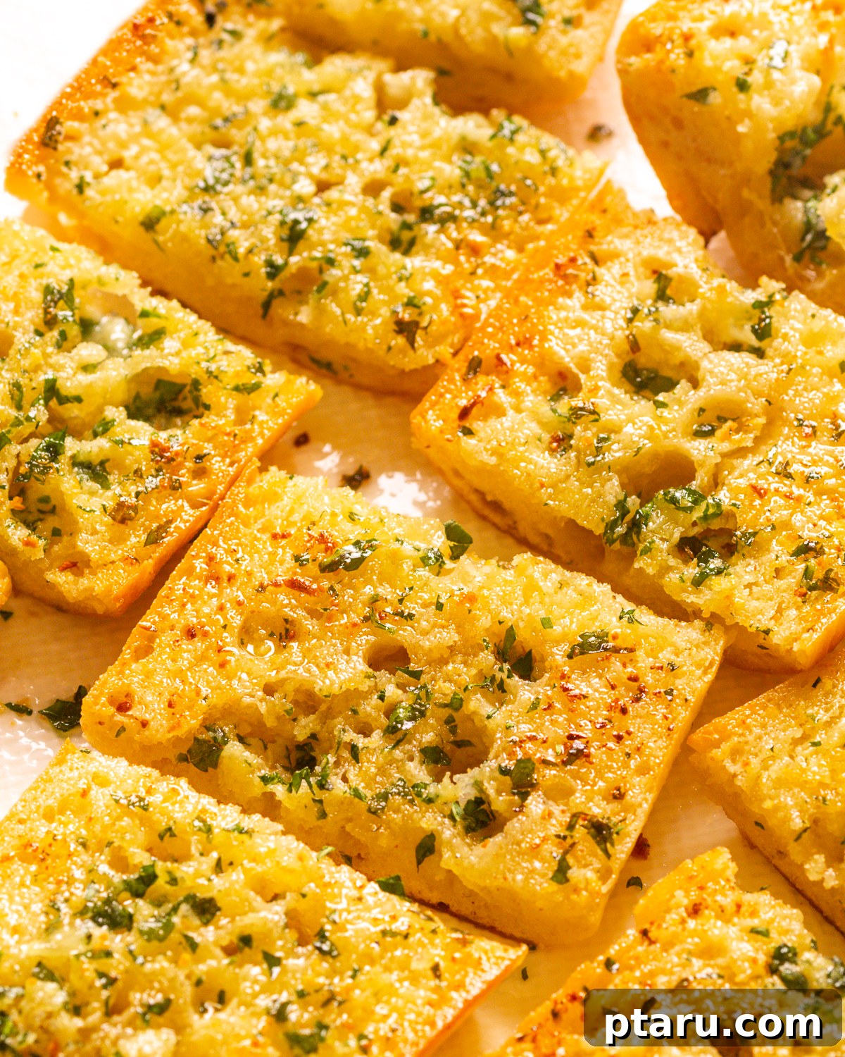 Homemade Garlic Bread That Outshines Restaurants 5 An irresistible close-up of homemade garlic bread with golden-brown crust and bubbling garlic butter.