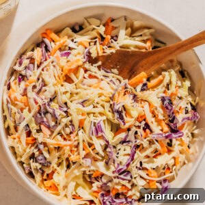 Coleslaw recipe in a bowl with a spoon.